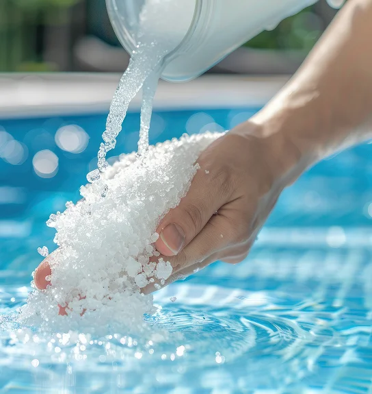 Pouring crushed ice into a hand above a pool.